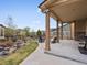 Cozy covered patio overlooks meticulously landscaped backyard, perfect for outdoor lounging at 2463 Tavern Way, Castle Rock, CO 80104