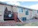 Exterior view of backyard with a deck, stairs, and manicured lawn at 8112 Gray Ct # 394, Arvada, CO 80003