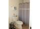 Functional bathroom featuring a toilet, shower with gray curtain, and towel rack at 8112 Gray Ct # 394, Arvada, CO 80003