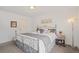 Bright bedroom featuring a silver metal bed frame, soft gray accents, and a cozy, inviting ambiance at 8112 Gray Ct # 394, Arvada, CO 80003