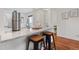 Bright kitchen bar featuring granite countertops, contemporary stools, and views of a well-lit space at 8112 Gray Ct # 394, Arvada, CO 80003