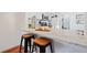 Modern kitchen bar with granite countertop, barstools, stainless steel appliances, and bright natural light at 8112 Gray Ct # 394, Arvada, CO 80003