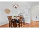 Cozy dining area with a wood table set beneath a decorative pendant light fixture, and white walls at 8112 Gray Ct # 394, Arvada, CO 80003
