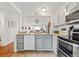Open kitchen with gray cabinets, granite countertops, stainless appliances, and a view of the dining area at 8112 Gray Ct # 394, Arvada, CO 80003