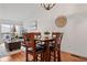 Bright dining area with hardwood floors, a stylish light fixture, and an adjacent living space at 8112 Gray Ct # 394, Arvada, CO 80003