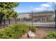 Community pool area behind a fence and surrounded by greenery at 8112 Gray Ct # 394, Arvada, CO 80003