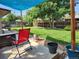 Backyard patio with nice lawn, small table, and fire pit under shade at 9231 Irving St, Westminster, CO 80031