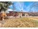 This backyard features a patio with seating, a lush lawn, and wood privacy fence at 9231 Irving St, Westminster, CO 80031