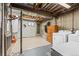 A utilitarian basement space includes laundry hookups, a small window, and exposed ceiling beams at 9231 Irving St, Westminster, CO 80031