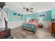 Spacious bedroom with wood-look flooring, a ceiling fan, and colorful decor at 9231 Irving St, Westminster, CO 80031