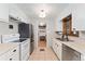 Well-lit kitchen features stainless steel appliances, classic white cabinets, and efficient layout at 9231 Irving St, Westminster, CO 80031