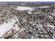 Aerial view of neighborhood with lake and city skyline in background at 1557 S Pierson St, Lakewood, CO 80232