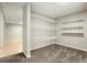 Basement storage room with wire shelving and carpeted floor at 1557 S Pierson St, Lakewood, CO 80232