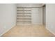 Finished basement room with tile floors and large shelving unit at 1557 S Pierson St, Lakewood, CO 80232