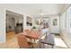 Bright dining room features a live-edge table and bench with kitchen views at 1557 S Pierson St, Lakewood, CO 80232