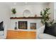 Modern fireplace with a white brick surround and wood mantel at 1557 S Pierson St, Lakewood, CO 80232