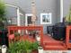 Charming back deck with a table and chairs, plants, and a grill, perfect for outdoor gatherings at 2285 S Jasper Way # A, Aurora, CO 80013
