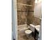 Well-appointed bathroom featuring a tiled shower/tub, toilet, sink, and decorative mosaic accents at 2285 S Jasper Way # A, Aurora, CO 80013