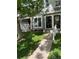 Charming townhome featuring a well-maintained lawn, concrete walkway, and gray siding with decorative trim at 2285 S Jasper Way # A, Aurora, CO 80013