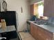 Functional kitchen with a black refrigerator, modern appliances, granite countertops, and ample natural light at 2285 S Jasper Way # A, Aurora, CO 80013