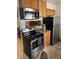 Modern kitchen featuring stainless steel appliances, granite countertops, and wooden cabinets for a sleek design at 2285 S Jasper Way # A, Aurora, CO 80013