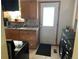 Kitchen with wooden cabinets, granite countertops, sink, and door to adjacent laundry room and outdoor access at 2285 S Jasper Way # A, Aurora, CO 80013