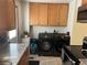 Convenient laundry area with modern washer and dryer, ample cabinet space, and granite countertops at 2285 S Jasper Way # A, Aurora, CO 80013