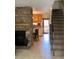 Inviting living room showcasing a stone fireplace, tiled floor and staircase access for a warm and cozy feel at 2285 S Jasper Way # A, Aurora, CO 80013