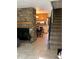 Inviting living room with a stone fireplace, stairway and open access to the dining area and kitchen at 2285 S Jasper Way # A, Aurora, CO 80013