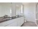 Modern bathroom with double vanity and dark countertop at 1940 S Haleyville Way, Aurora, CO 80018