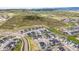 Stunning aerial view of a new home community surrounded by lush green space and mountain views at 5411 Edenborn Way, Castle Rock, CO 80104