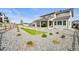 Beautiful backyard with gravel landscaping, a grassy lawn, and a covered patio with comfortable seating at 5411 Edenborn Way, Castle Rock, CO 80104