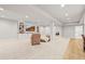Spacious finished basement with TV, built-in shelves, seating, and plush carpeting at 5411 Edenborn Way, Castle Rock, CO 80104