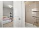 Bright bathroom featuring a shower/tub combination with tile surround and a bedroom view at 5411 Edenborn Way, Castle Rock, CO 80104