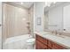 Standard bathroom featuring shower over tub, neutral tile, and classic vanity at 5411 Edenborn Way, Castle Rock, CO 80104
