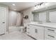 Bathroom featuring a white vanity, large mirror, and tub with tiled shower at 5411 Edenborn Way, Castle Rock, CO 80104