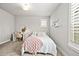 Bright bedroom with a desk and chair, soft lighting, and a bright window at 5411 Edenborn Way, Castle Rock, CO 80104