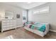 Cozy bedroom with a daybed featuring built-in storage and a large dresser with a vanity mirror at 5411 Edenborn Way, Castle Rock, CO 80104