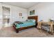 Bright bedroom with a full bed, desk, and view to the upstairs hallway at 5411 Edenborn Way, Castle Rock, CO 80104
