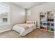 Bright bedroom with a full bed, shelving for books, and a large window with shutter-style blinds at 5411 Edenborn Way, Castle Rock, CO 80104