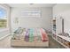 Bright bedroom with a trundle bed, large window, and built-in shelving at 5411 Edenborn Way, Castle Rock, CO 80104