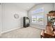 Bright bonus room with neutral walls, carpet, and vaulted ceiling, featuring built-in storage and a large window at 5411 Edenborn Way, Castle Rock, CO 80104