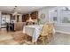 Bright dining area with views to kitchen features wood floors, modern decor, and a gas range at 5411 Edenborn Way, Castle Rock, CO 80104