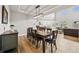Open dining room with wood floors and a modern lighting fixture at 5411 Edenborn Way, Castle Rock, CO 80104