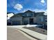 Attractive two-story home featuring a two-car garage, stone accents, and manicured landscaping under a cloudy blue sky at 5411 Edenborn Way, Castle Rock, CO 80104
