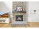 Cozy fireplace with stone surround and hearth at 5411 Edenborn Way, Castle Rock, CO 80104