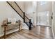 Welcoming foyer with soaring ceilings, wood floors and a wrought iron staircase with views to the entry door at 5411 Edenborn Way, Castle Rock, CO 80104