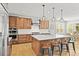 Modern kitchen with stainless steel appliances, island with seating, and wood cabinetry at 5411 Edenborn Way, Castle Rock, CO 80104