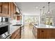 Gourmet kitchen boasts stainless steel appliances, a large island with seating, and views of the breakfast nook at 5411 Edenborn Way, Castle Rock, CO 80104