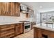 Gourmet kitchen featuring stainless appliances, white countertops, wood cabinets and a gas range at 5411 Edenborn Way, Castle Rock, CO 80104